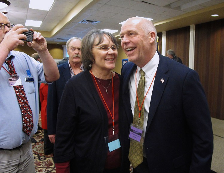 Greg Gianforte, right, receives congratulations from a supporter in Helena, Mont., on March 6. Gianforte won his election Thursday despite being charged with assault.