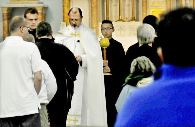 The Rev. James Doran conducts Mass for nearly 70 parishioners Sunday at the St. Joseph Maronite Catholic Church in Waterville. 