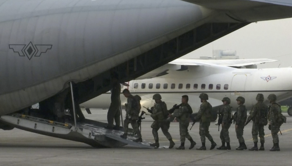 In this image made from video, marines board a transport plane in Manila, Philippines. A marine battalion left an air force base in Manila on deployment to the southern city of Marawi where ongoing violence has killed scores of people.