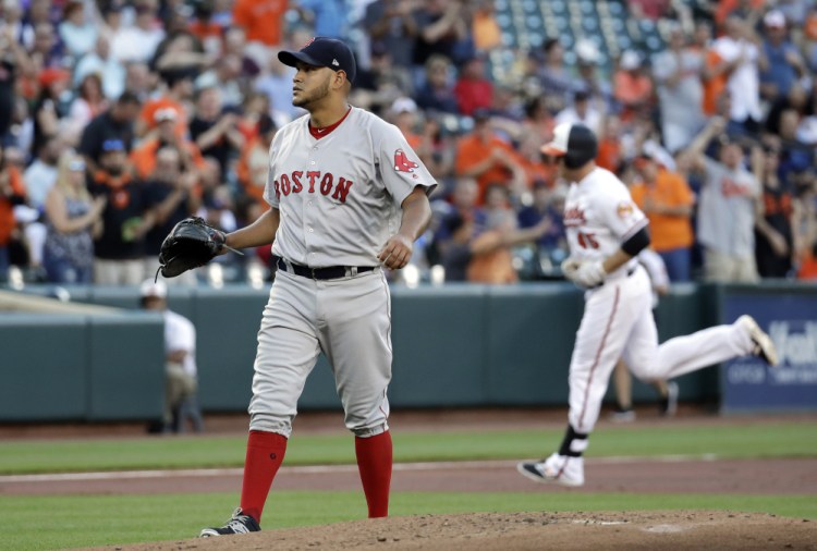 Red Sox starting pitcher Eduardo Rodriguez waits for Baltimore's Mark Trumbo to finish rounding the bases on a two-run home run during the first inning Thursday night in Baltimore.