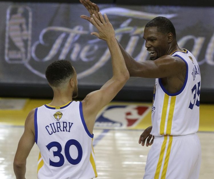 Golden State guard Stephen Curry and forward Kevin Durant react after scoring against the Cleveland Cavaliers in the first half of Game 1 of NBA Finals Thursday night in Oakland, Calif.