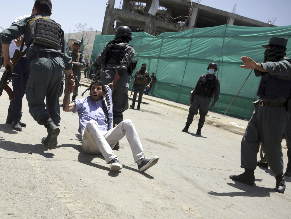 Police arrest a protester during a demonstration in Kabul, Afghanistan, Friday. Hundreds of demonstrators demanded better security in the Afghan capital in the wake of a powerful truck bomb attack that killed 90 people.