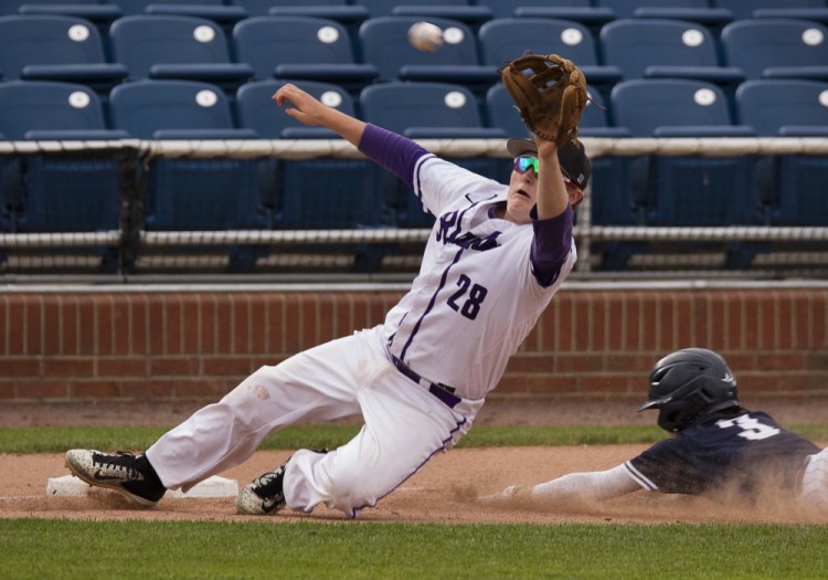 Deering third baseman Alex McGonagle dives off the base Friday to catch an off-the-mark throw as Ben Stasium of Portland slides safely with a steal. Deering had to play two games at Hadlock Field – losing both – to complete a weather-hampered baseball schedule.