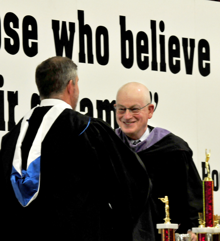 Maine Central Institute Headmaster Christopher Hopkins, left, introduces commencement speaker Norbert Young Jr., class of 1966, during commencement in Pittsfield on Sunday. 
