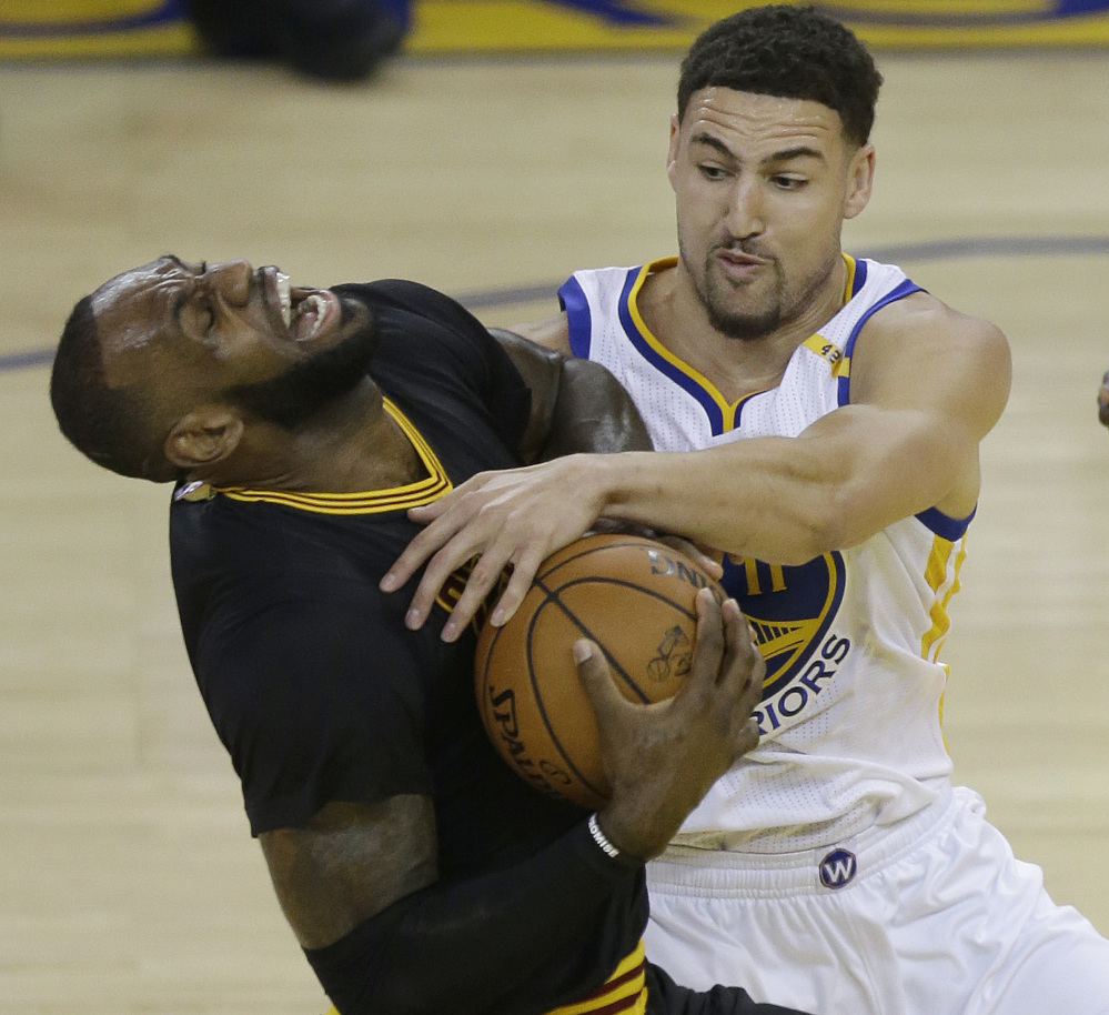Associated Press/Ben Margot
Klay Thompson fouls Cleveland's LeBron James, who did his best to give the Cavaliers a chance by recording a triple-double, but Cleveland returns home in a 2-0 hole.