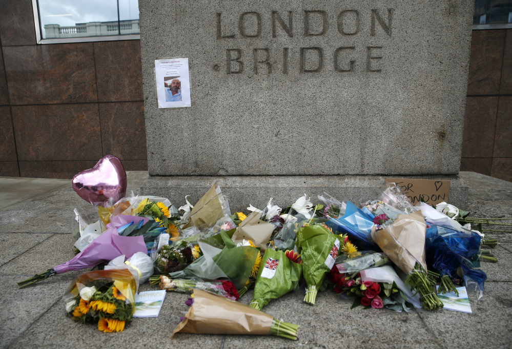 A floral tribute is seen in the London Bridge area Monday. Police arrested several people and are widening their investigation after a series of attacks described as terrorism killed several people and injured more than 40 others in the heart of London on Saturday.
