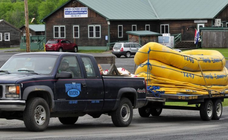 A North Country Rivers employee hauls a trailer full of white water rafts while leaving the base lodge of the company in Bingham on Monday. The Maine Warden Service continues to investigate the death of Richard Sanders on Saturday after the raft he was in flipped over on the Dead River.