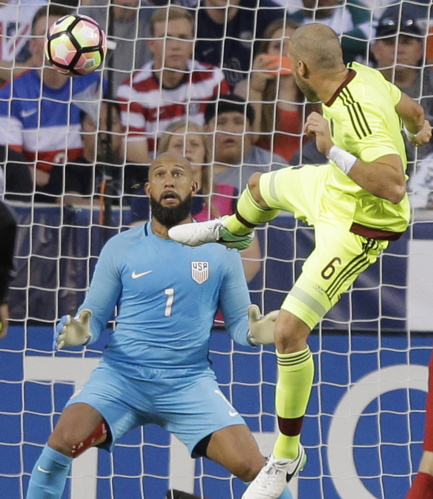 Tim Howard couldn't stop this header by Venezuela's Jose Manuel Velazquez, and the U.S. settled for a 1-1 draw Saturday in Sandy, Utah, as the team tuned up for Thursday's World Cup qualifier against Trinidad and Tobago.