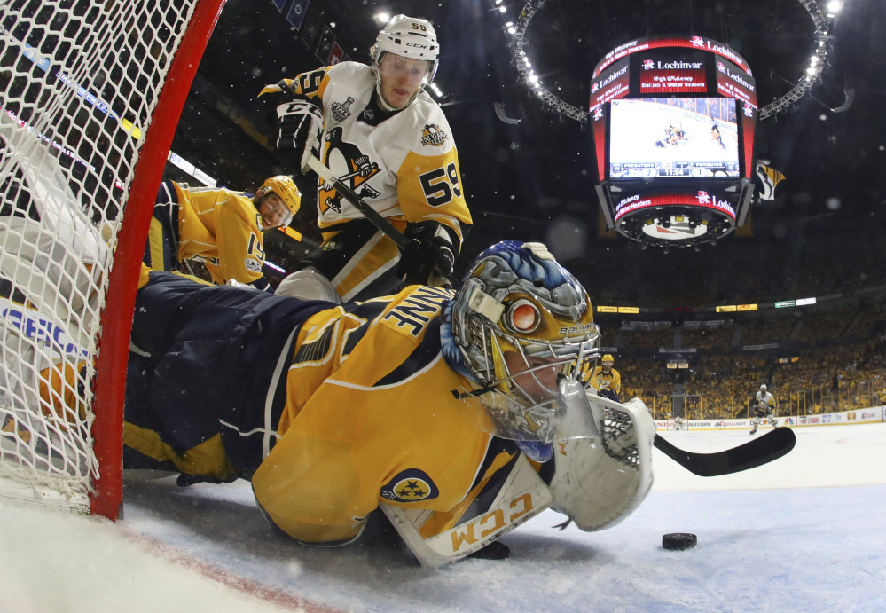 Nashville goalie Pekka Rinne stops a shot by Pittsburgh center Jake Guentzel in the second period of Game 4 of the Stanley Cup Final on Monday night in Nashville, Tenn.