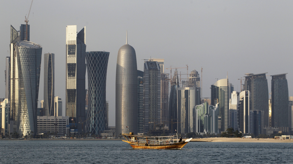 A traditional dhow floats in the Corniche Bay of Doha, Qatar, with tall buildings of the financial district in the background, in this 2011 photo. Qatar is now facing a diplomatic crisis with other Arab nations, which accuse it of backing terror groups and Iran.