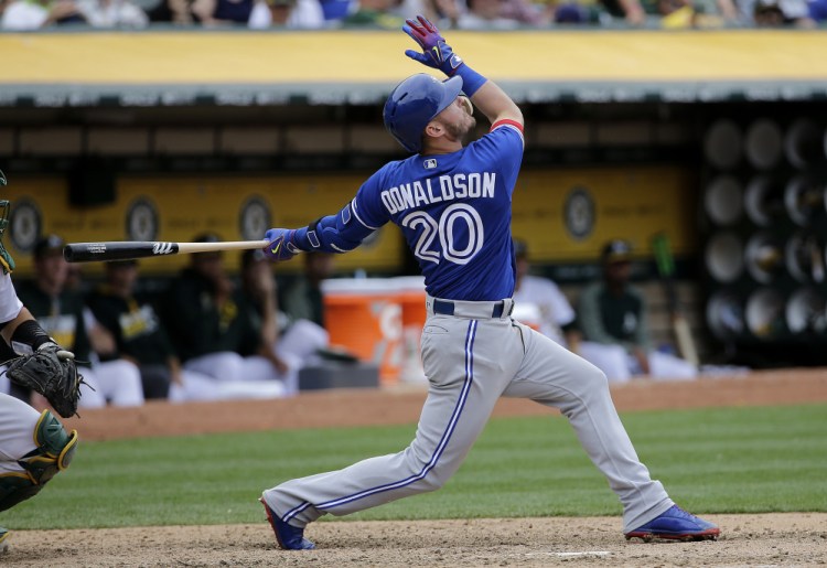 Josh Donaldson of the Toronto Blue Jays hits a two-run, tie-breaking homer during the 10th inning of Wednesday's 7-4 victory at Oakland. With the win, the Jays averted a sweep.