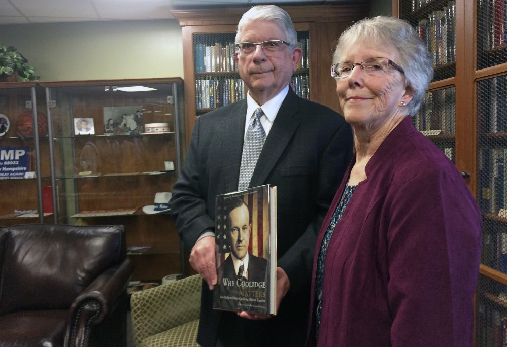 Arthur Young, left, and his wife, Pat, hold one of the 2,744 books about U.S. presidents he donated to the New Hampshire Political Library, part of the New Hampshire Institute of Politics at St.  Anselm College in Manchester, N.H., on Friday. There is no Trump among the works – yet.