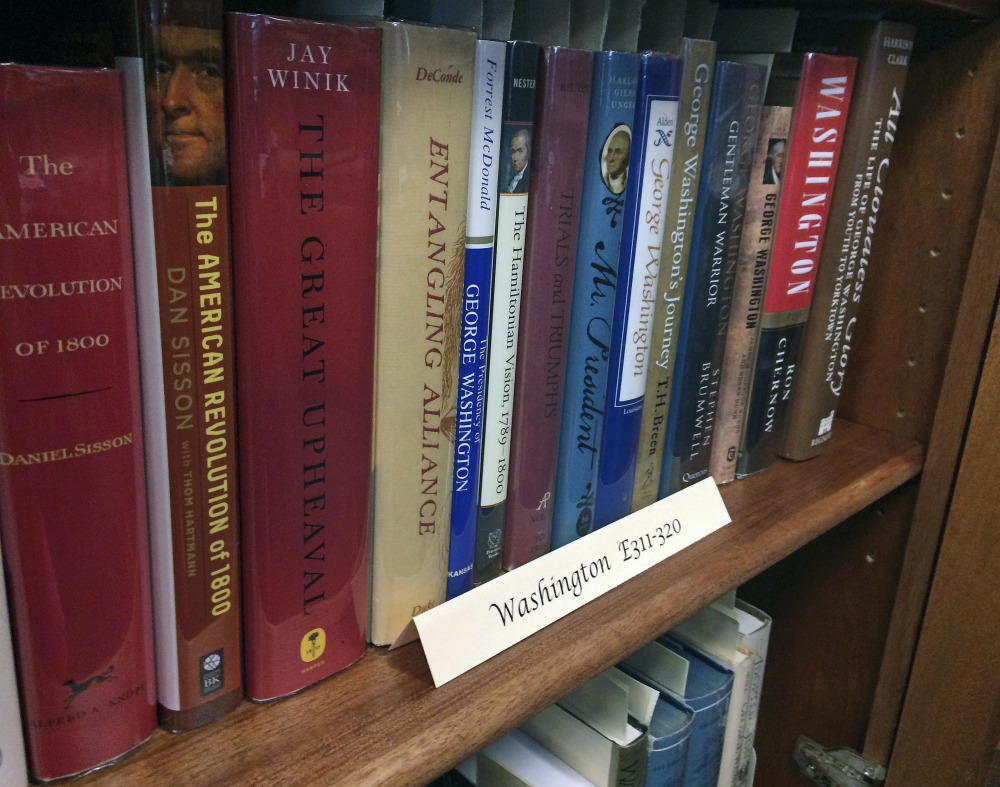 A row of books about President George Washington line a shelf at the New Hampshire Political Library at Saint Anselm College in Manchester, N.H., on Friday, June 9, 2017. Retired librarian Arthur Young donated 2,744 books to the college's New Hampshire Institute of Politics, where staffers spent six months cataloguing them and building custom display cases. (AP Photo/Holly Ramer)