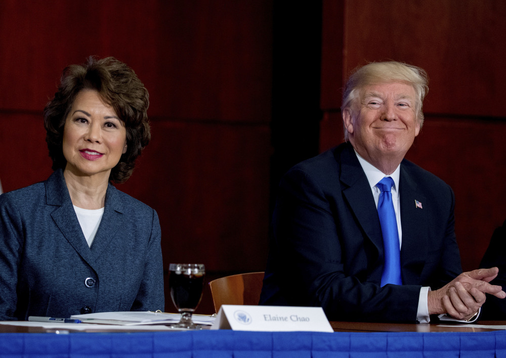 President Trump, with Transportation Secretary Elaine Chao, left, attends a roundtable on infrastructure at the Department of Transportation on Friday in Washington.