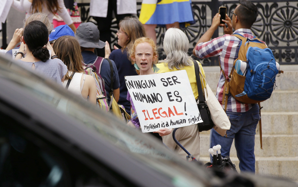 Associated Press/Stephan Savoia
Bostonian Anna Hadingham's sign translates as "No Human Is Illegal" during a Sanctuary State Rally outside the Massachusetts Statehouse Friday in Boston. Inside the building, a sanctuary bill was discussed.