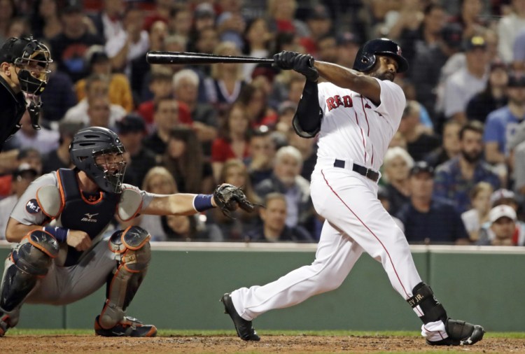 Boston's Jackie Bradley Jr. hits a two-run home run in the eighth inning Friday night at Fenway Park.