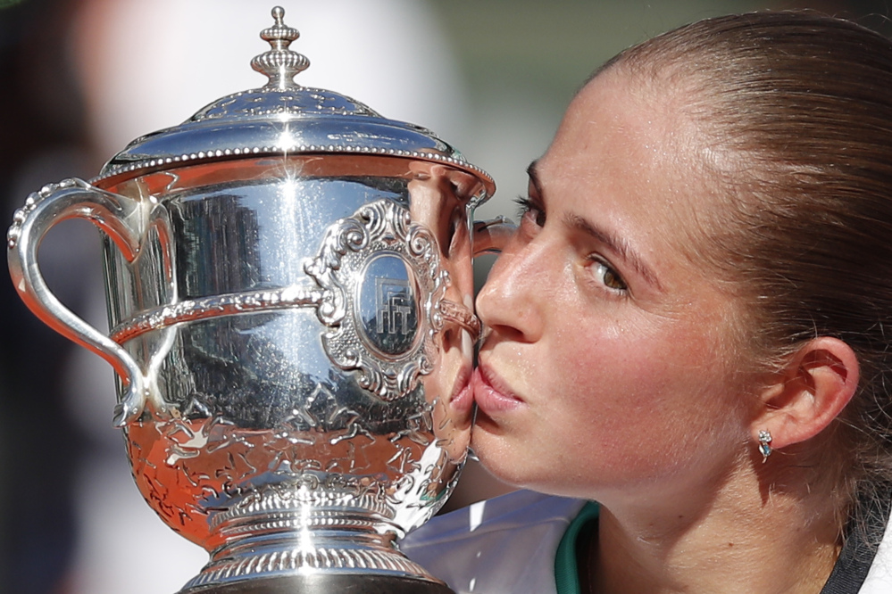 Latvia's Jelena Ostapenko kisses the trophy after winning the women's final match of the French Open tennis tournament against Romania's Simona Halep in three sets 4-6, 6-4, 6-3, at the Roland Garros stadium, in Paris, France, Saturday, June 10, 2017. (Associated Press/Christophe Ena)