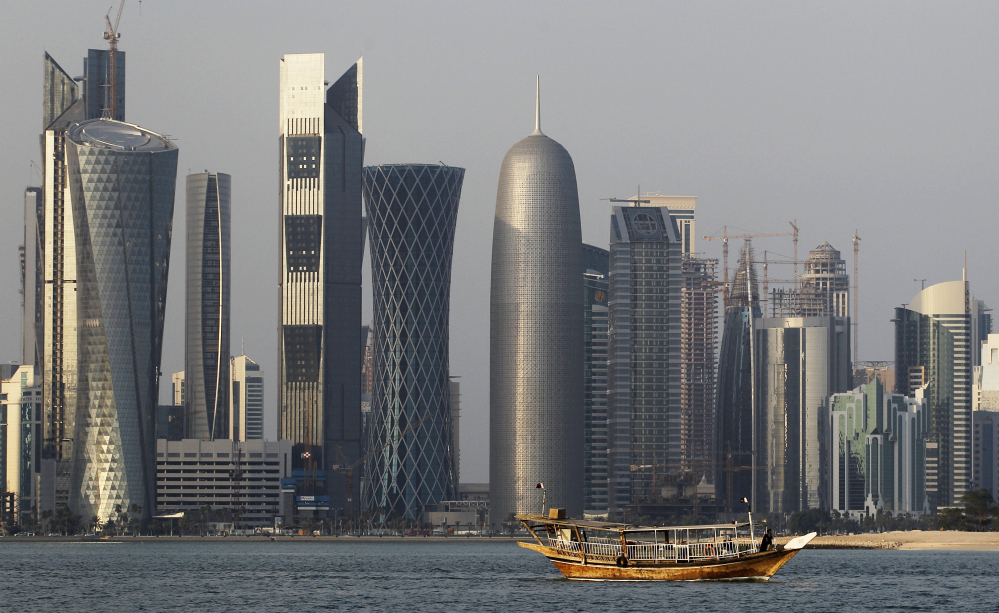 A traditional dhow floating in the Corniche Bay of Doha, Qatar, contrasts with tall buildings of the financial district. Qatar is facing a diplomatic crisis with other Arab nations.