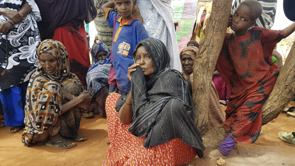 Ader Ali Yusuf, center, a mother of 12 who was displaced from her village because of the ongoing drought in Ethiopia, sits among a group of women and children Friday in a town near Ethiopia's border with Somalia.