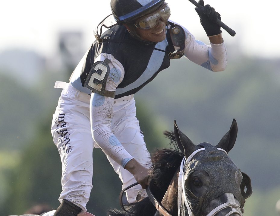 Jose Ortiz celebrates Saturday after riding Tapwrit to a come-from-behind victory in the Belmont Stakes, the finale of the Triple Crown series.