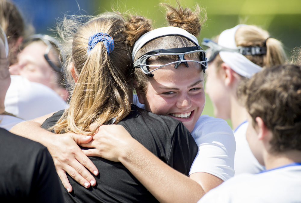 Kayla Sarazin hugs a teammate after Falmouth earned a spot in the regional final Wednesday against top-seeded Kennebunk.