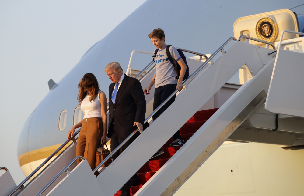 President Trump steps off Air Force One with first lady Melania Trump, left, and son Barron after arriving at Andrews Air Force Base, Md., on Sunday. Trump returned to Washington after spending the weekend at Trump National Golf Club in Bedminster, N.J.