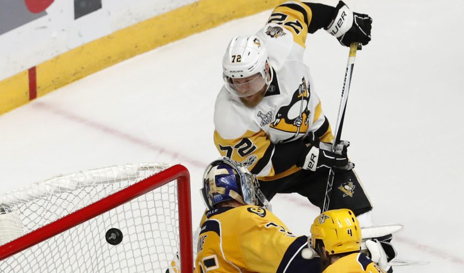Patric Hornqvist banks the puck into the net off the back of Nashville goalie Pekka Rinne, snapping a scoreless tie and lifting the Penguins to a Cup-clinching 2-0 victory Sunday.