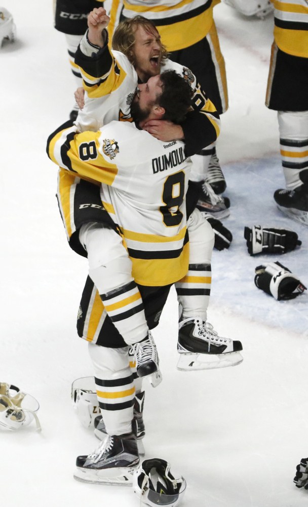 Biddeford-born Brian Dumoulin lifts Carl Hagelin after the Penguins clinched their second straight Stanley Cup Sunday night.