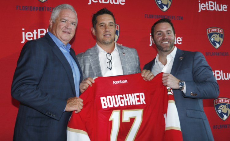 Bob Boughner, center, poses with Dale Tallon, Florida Panthers president of hockey operations, and Matthew Caldwell, president and CEO, after being named coach.