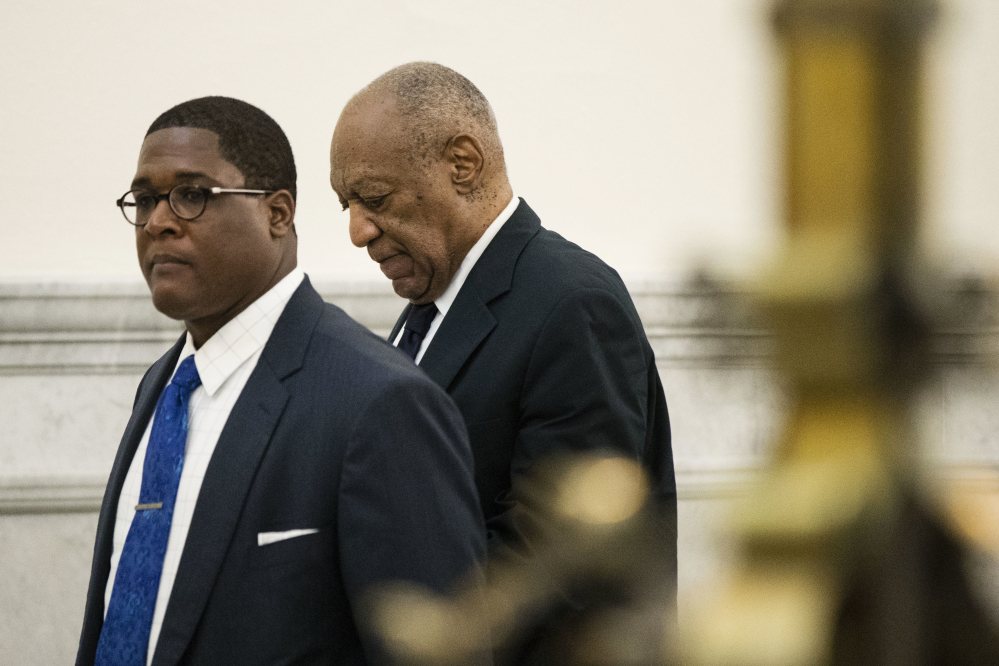 Bill Cosby, accompanied by Andrew Wyatt, walks to the courtroom during jury deliberations in his sexual assault trial at the Montgomery County Courthouse in Norristown, Pa., on Tuesday.