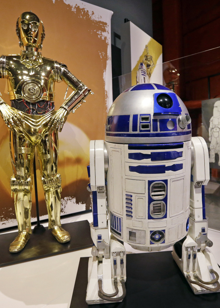 C-3PO, left, and R2-D2 costumes are shown in a previous exhibit at Seattle's EMP Museum. 