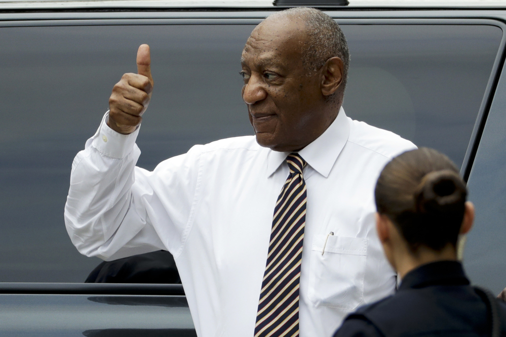 Bill Cosby gives a thumbs-up as he arrives at the Montgomery County Courthouse on Wednesday for another day of jury deliberations in his sexual-assault trial.
