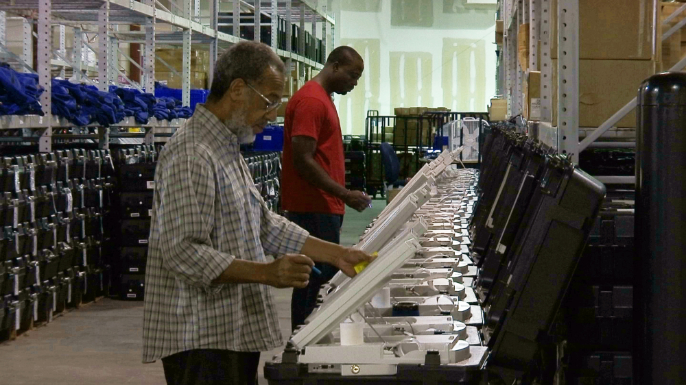 Employees of the Fulton County Election Preparation Center in Atlanta test electronic voting machines last September. A security researcher disclosed a gaping security hole at the outfit that manages Georgia's elections. The breach left the state's 6.7 million voter records and other sensitive files exposed to hackers.
