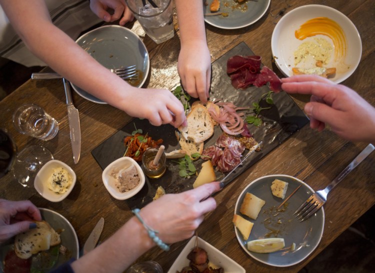 The Murphy family of Scarborough digs into a meat and cheese plate at Northern Union.