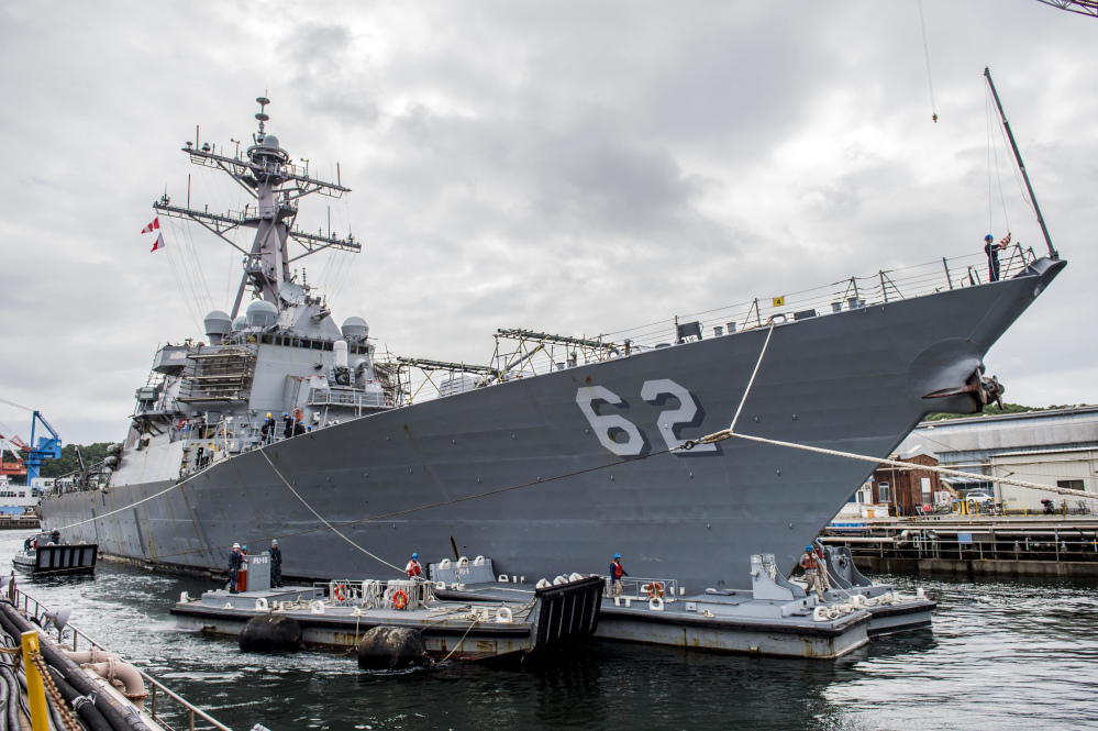 The Arleigh Burke-class guided-missile destroyer USS Fitzgerald (DDG 62) is shown pulling into a dry dock in Yokosuka, Japan, on June 15, 2016. The U.S. military says the Navy destroyer collided with a merchant ship off the coast of Japan and there have been injuries.