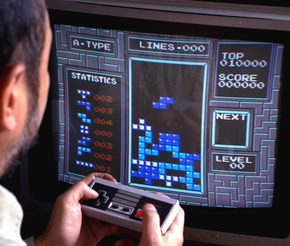 A Nintendo gamer plays "Tetris" in this photo from June 1990. This weekend, audiences will pack a concert hall in Paris to hear the London Symphony Orchestra performing videogame music.