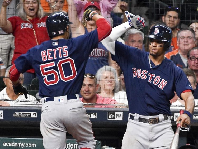 Boston's Mookie Betts celebrates his go-ahead home run off Houston reliever Will Harris with Xander Bogaerts during the eighth inning of Friday night's game in Houston.