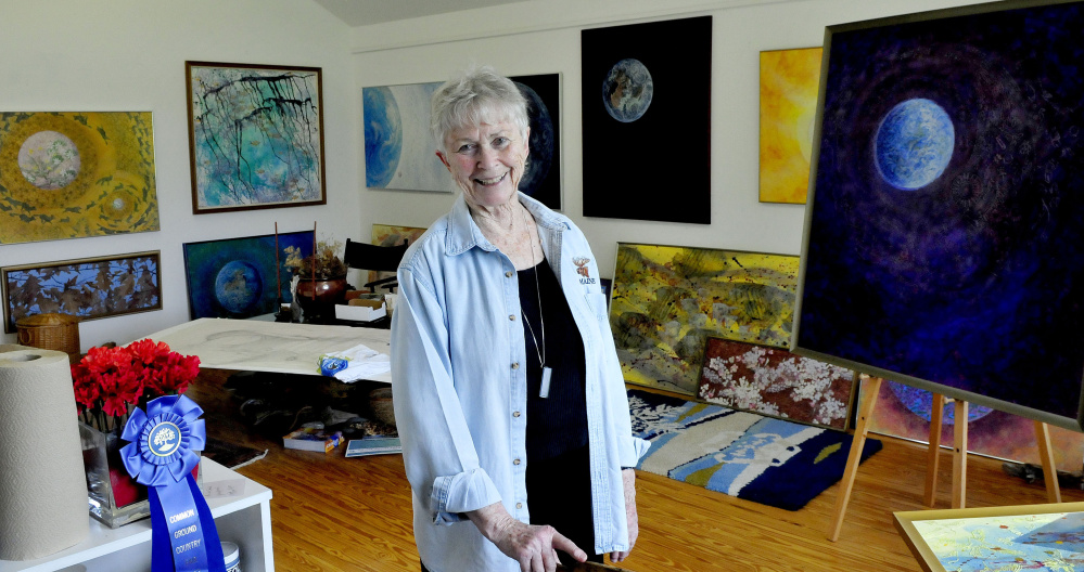 Winslow-based artist Jean Ann Pollard on Tuesday inside her studio, surrounded by artwork related to other pieces in the national Citizens' Climate Lobby project in Washington, D.C.