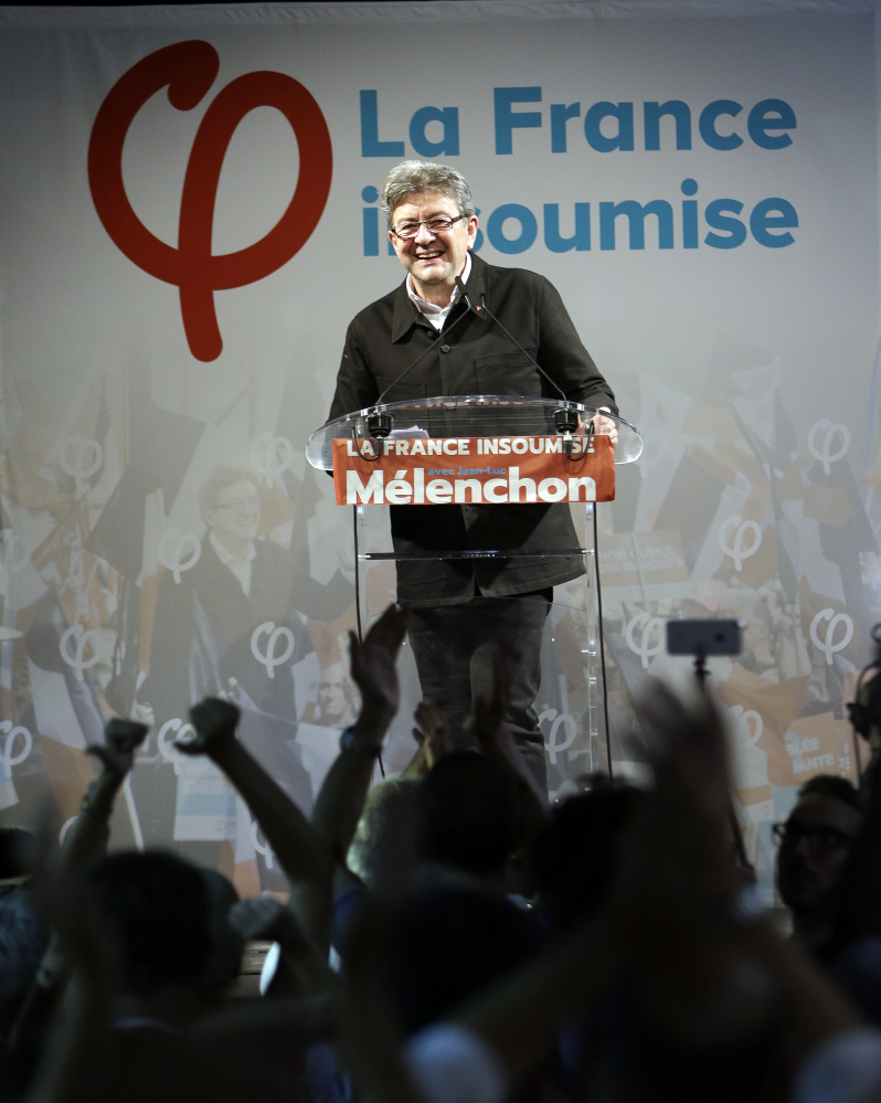 Far-left ex-presidential candidate and candidate in the parliamentary elections Jean-Luc Melenchon celebrates with his supporters after winning his race for a parliamentary seat in Marseille southern France, Sunday, June 18, 2017. French voters are casting ballots Sunday in the final round of parliamentary elections that could clinch President Emmanuel Macron's hold on power, as his fledgling party appears set to rout mainstream rivals and turn politics as usual on its head.(AP Photo/Claude Paris)