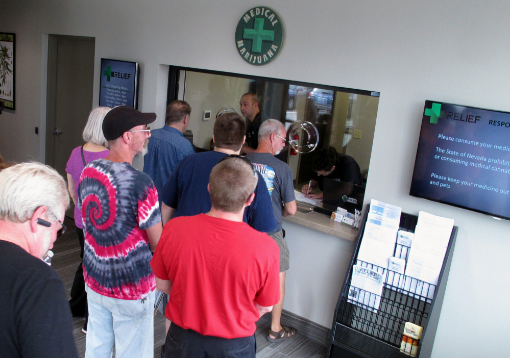 People line up to be among the first in Nevada to legally purchase medical marijuana at the Silver State Relief dispensary in Sparks, Nev., in 2015. Nevada's marijuana regulators are working to launch recreational sales on July 1, a deadline that could hinge on a court deciding whether the state's liquor industry should be guaranteed a piece of the pot pie before tourists and residents can light up.