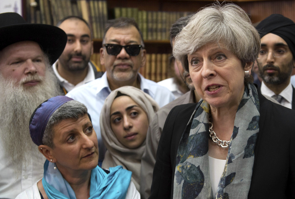 British Prime Minister Theresa May talks to faith leaders at Finsbury Park Mosque in north London, after an attack there.