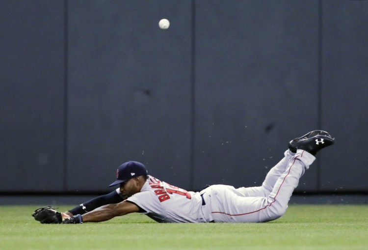 Red Sox center fielder Jackie Bradley Jr. dives but misses a fly ball by the Royals' Drew Butera, who got a triple on the seventh-inning play and later scored what proved to be the game-winning run.