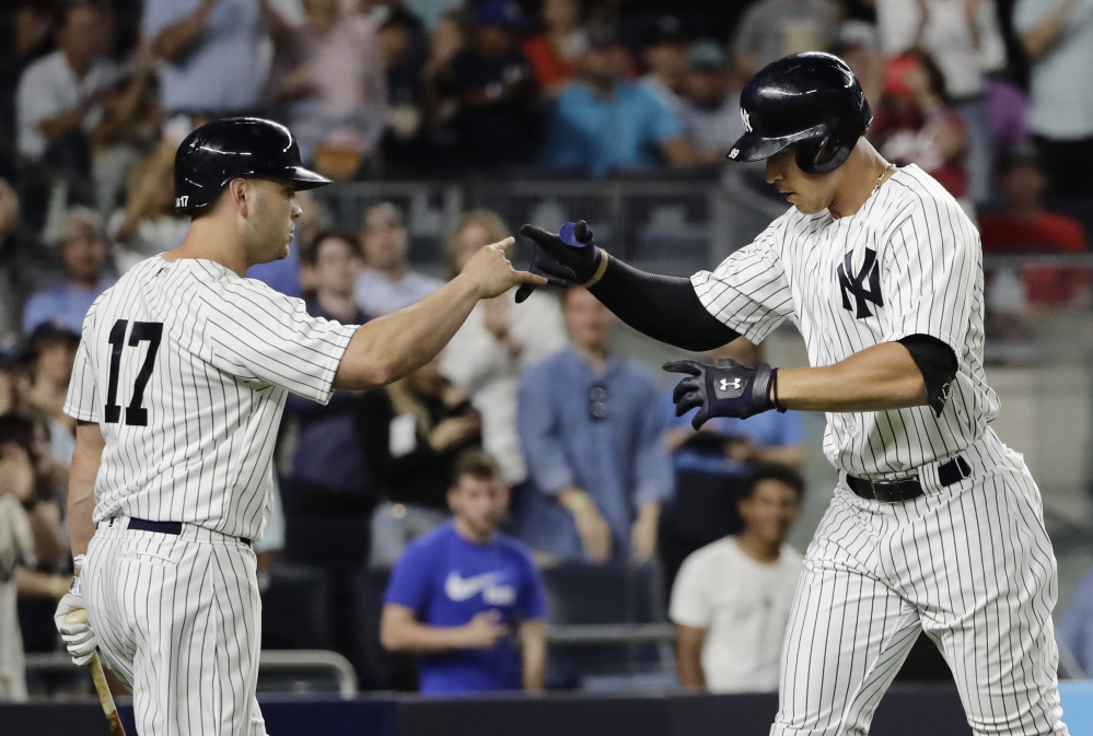 The Yankees' Aaron Judge, right, celebrates with Matt Holliday after hitting his major league-leading 24th home run in the fifth inning Tuesday night, but the Angels went on to an 8-3 victory.