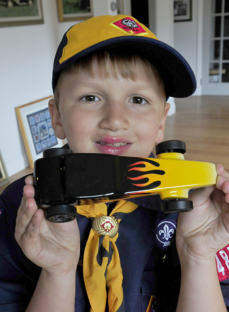 Cub Scout Trevor Russell, 8, of North Anson displays his entry in the 2017 World Championship Pinewood Derby competition on Wednesday. The competition is being held in Times Square in New York City.