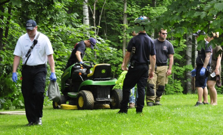 Waterville firefighters helped pull an injured man from a wooded area Wednesday after the lawn mower he was riding toppled down an embankment in Waterville.