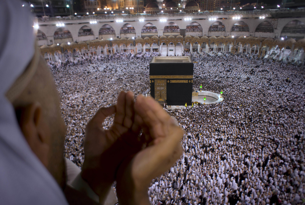 A Muslim worshipper prays during the holy month of Ramadan as pilgrims circumambulate around the Kaaba, the cubic building at the Grand Mosque, in Mecca, Saudi Arabia.