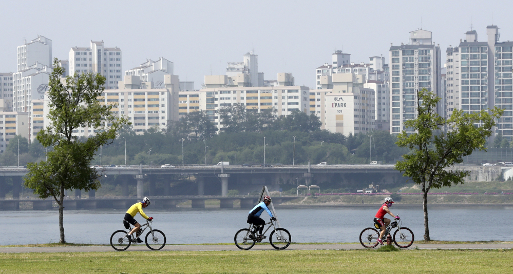 Cyclists ride along the Han River in Seoul, South Korea, on June 15. The nation's multimillion-dollar network of bike paths winds through urban and rural areas, covers 1,677 miles so far – and is still under construction.