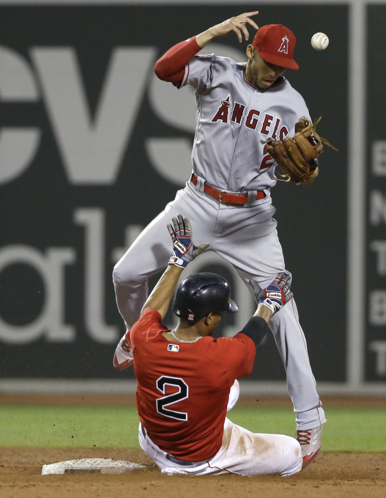 Xander Bogaerts of the Boston Red Sox takes out shortstop Andrelton Simmons of the Los Angeles Angels in an attempt to break up a double play Friday night at Fenway Park. Umpires ruled that Bogaerts interfered with Simmons.