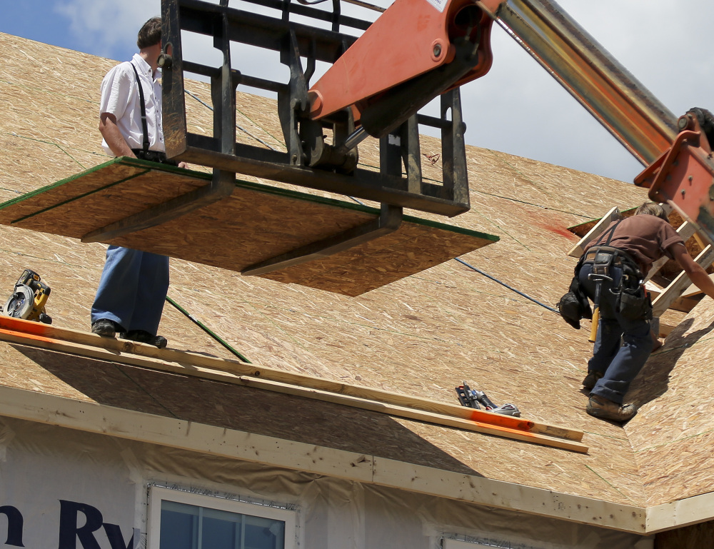 Builders this month work on a home under construction at a project in Jackson Township, Butler County, Pa. The Commerce Department reported Friday that new home sales in the U.S. had climbed 2.9 percent in May.