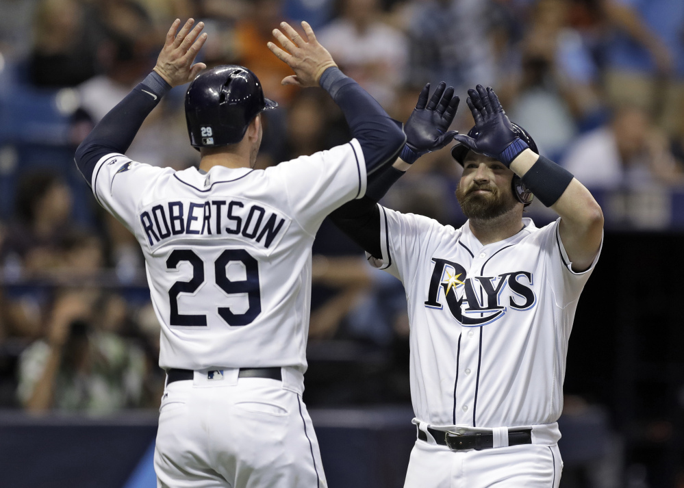 Derek Norris of the Tampa Bay Rays high-fives Daniel Robertson after hitting a two-run homer off Baltimore Orioles starting pitcher Ubaldo Jimenez during the third inning of Friday's game.
